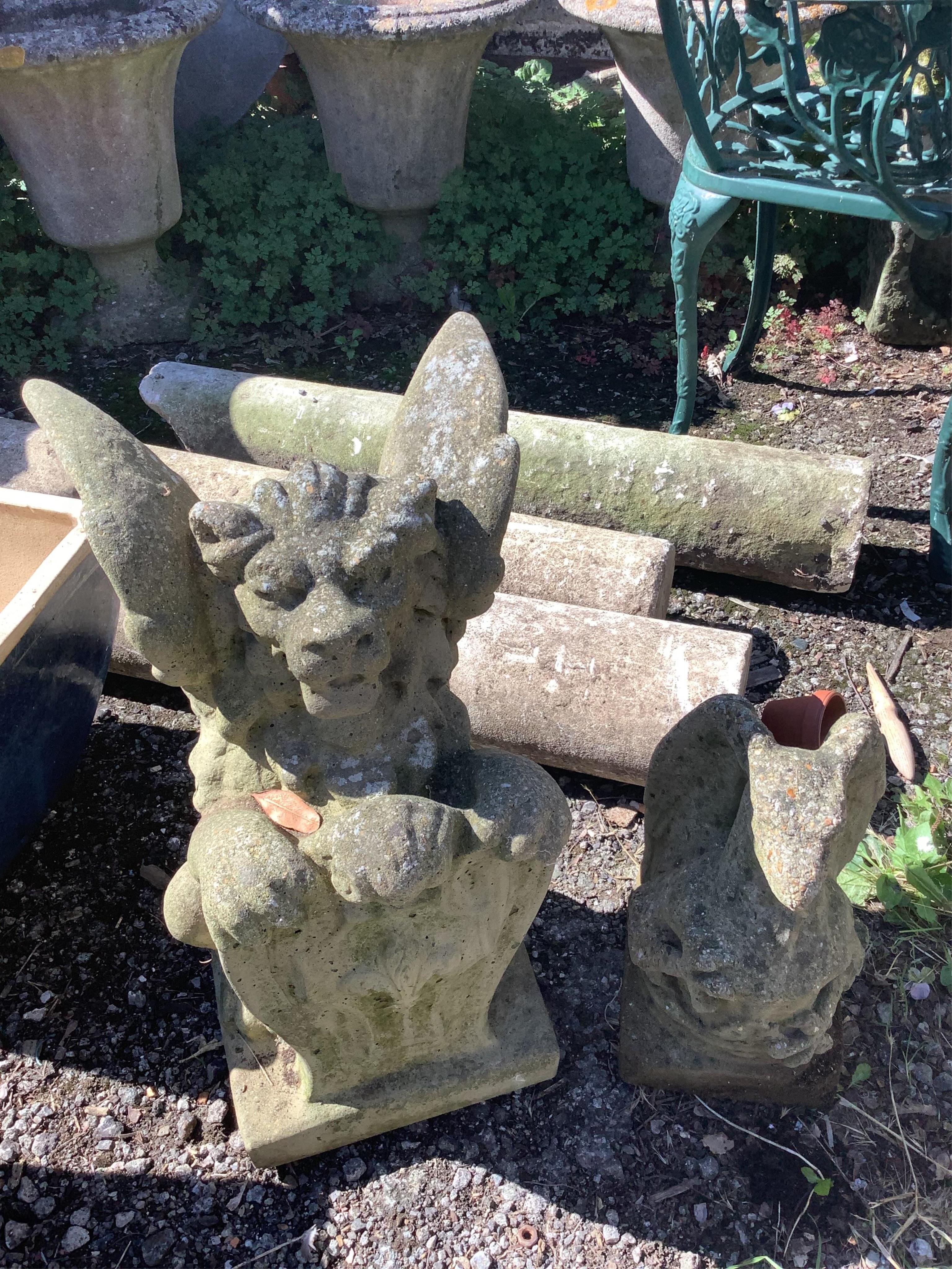 Two reconstituted stone winged lion and gargoyle garden ornaments, larger height 56cm. Condition - fair